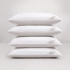Four white pillows stacked vertically on a light gray studio background. A small fabric tag on the right side of each pillow reads Pure Encapsulated.